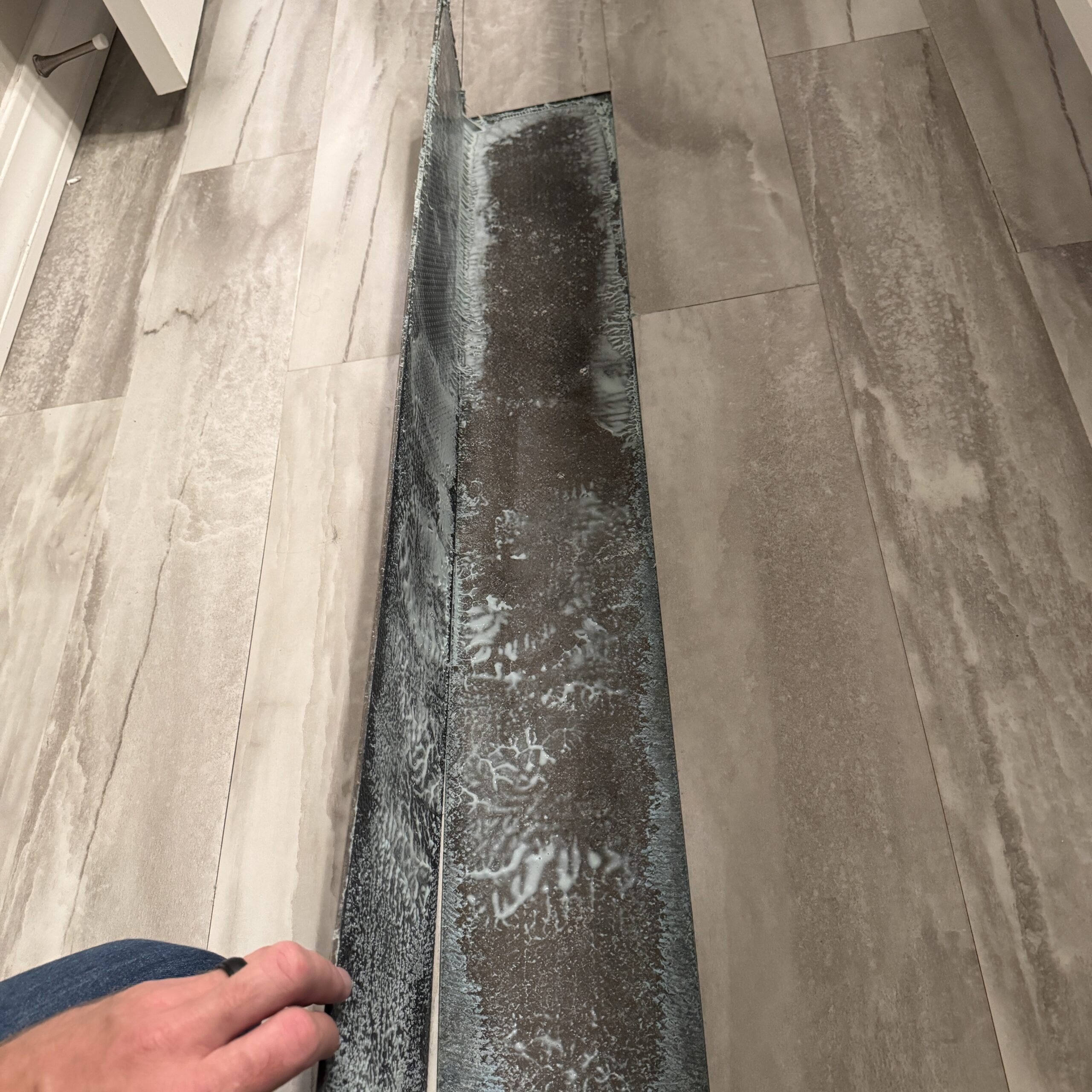 Home Inspection Defect | Failing Bathroom Vinyl Flooring Installation